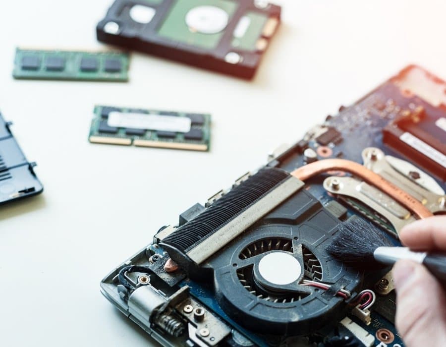Professional IT support technician in Cameroon monitoring business systems, troubleshooting devices, and providing technical assistance in a modern office.